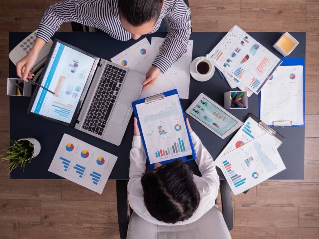 top-viewtop-view-manager-employee-doing-teamwork-business-office-looking-charts-laptop-display-1024x768 (1)